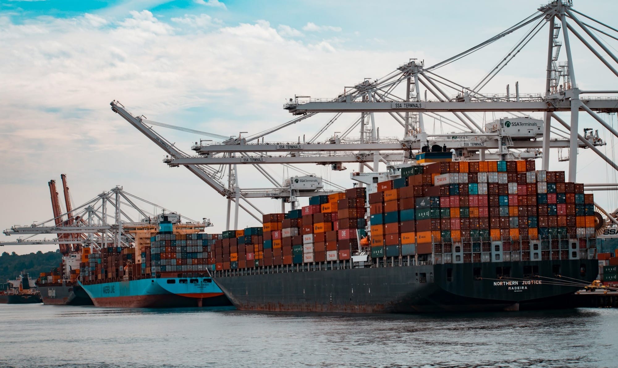 cargo ships docked at the pier during day