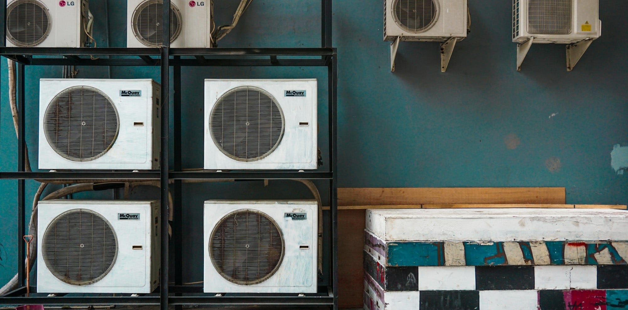 white and black box fan on brown wooden shelf