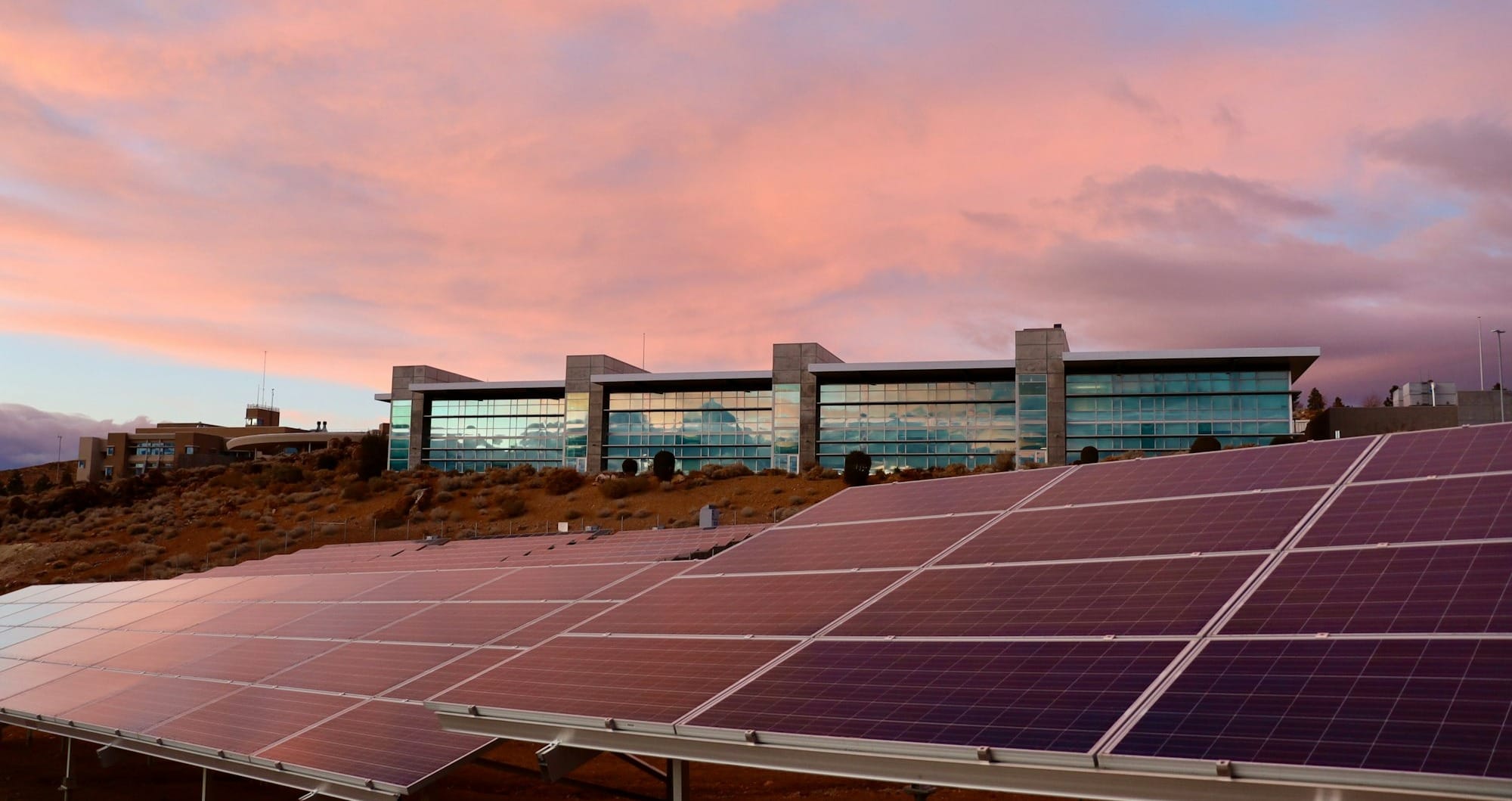 solar panels on brown field under white clouds during daytime